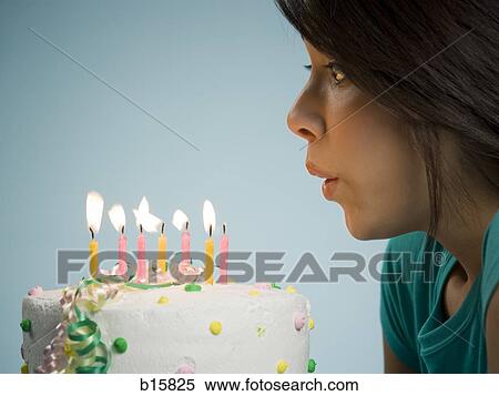 Profile of woman blowing out candles on birthday cake View Large Photo Image Stock Photography - Profile of woman blowing out candles on birthday cake. Fotosearch