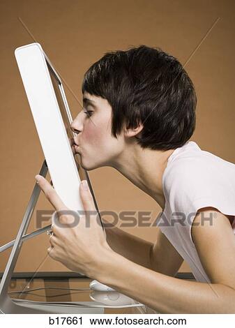 Profile of woman kissing computer monitor View Large Photo Image Stock Image - Profile of woman kissing computer monitor. Fotosearch