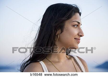 Profile of woman outdoors smiling View Large Photo Image Stock Photo - Profile of woman outdoors smiling. Fotosearch