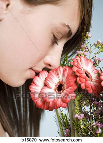 Profile of woman smelling flowers View Large Photo Image Stock Image - Profile of woman smelling flowers. Fotosearch