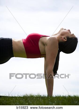 Profile of woman stretching outdoors on grass View Large Photo Image Stock Image - Profile of woman stretching outdoors on grass. Fotosearch
