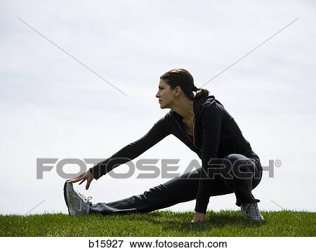 Profile of woman stretching outdoors View Large Photo Image Stock Photo - Profile of woman stretching outdoors. Fotosearch