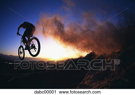 Rear view of cyclist at sunrise or sunset View Large Photo Image Stock Image - Rear view of cyclist at sunrise or sunset. Fotosearch