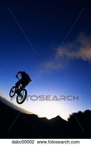 Rear view of cyclist at sunrise or sunset View Large Photo Image Stock Image - Rear view of cyclist at sunrise or sunset. Fotosearch