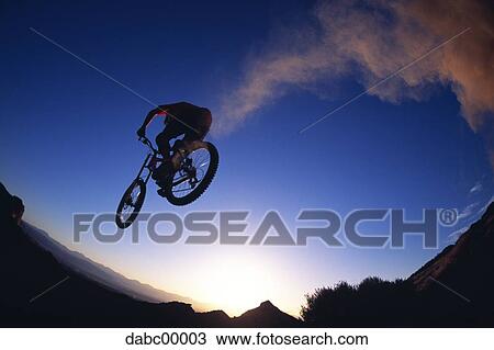 Rear view of cyclist at sunrise or sunset View Large Photo Image Stock Image - Rear view of cyclist at sunrise or sunset. Fotosearch