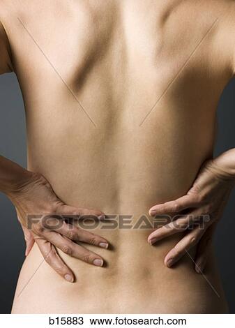 Rear view of topless woman with hands on lower back waist up View Large Photo Image Stock Image - Rear view of topless woman with hands on lower back waist up. Fotosearch