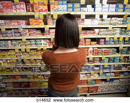 Rear view of woman in medicine aisle View Large Photo Image Stock Image - Rear view of woman in medicine aisle. Fotosearch
