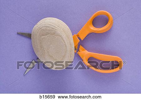 Rock with broken scissors View Large Photo Image Stock Photo - Rock with broken scissors. Fotosearch