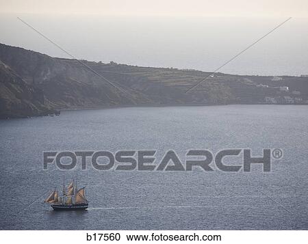 Sailboat on body of water with mountains View Large Photo Image Stock Image - Sailboat on body of water with mountains. Fotosearch