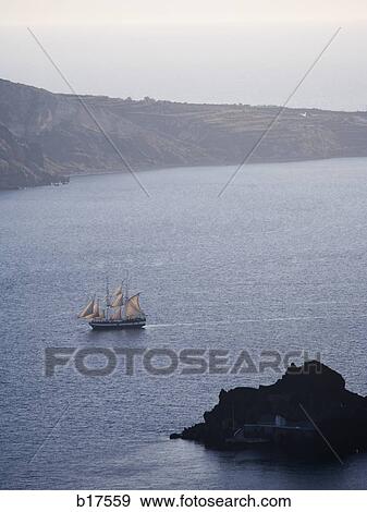 Sailboat on body of water with mountains View Large Photo Image Stock Photo - Sailboat on body of water with mountains. Fotosearch