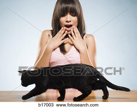 Scared woman with black kitten View Large Photo Image Stock Image - Scared woman with black kitten. Fotosearch