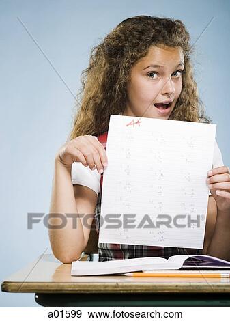 Schoolgirl holding A plus paper View Large Photo Image Stock Photo - Schoolgirl holding A plus paper. Fotosearch