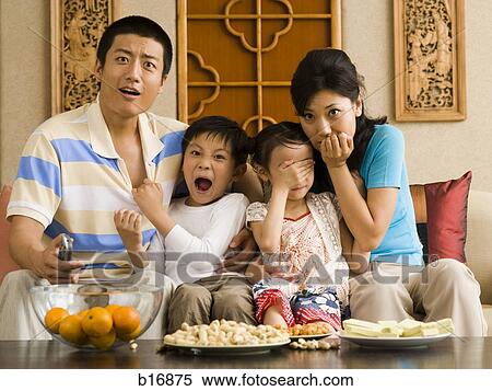 Shocked family watching television View Large Photo Image Stock Photography - Shocked family watching television. Fotosearch