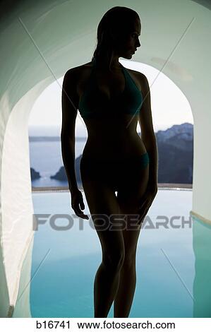 Silhouette of woman in swimsuit in infinity pool View Large Photo Image Stock Image - Silhouette of woman in swimsuit in infinity pool. Fotosearch