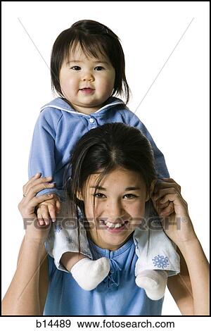 sisters on shoulders smiling View Large Photo Image Stock Photo - sisters on shoulders smiling. Fotosearch