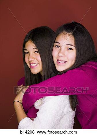 Sisters smiling and hugging. View Large Photo Image Stock Photo - Sisters smiling and hugging.. Fotosearch