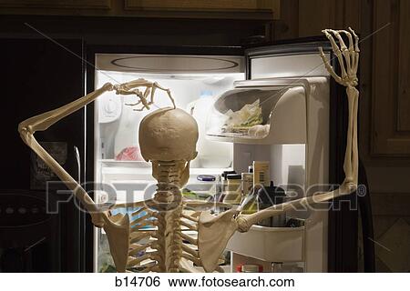 Stock Photograph - Skeleton looking inside refrigerator. Fotosearch