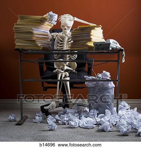 Skeleton sitting at desk with stacks of paperwork and crumpled papers View Large Photo Image Stock Photograph - Skeleton sitting at desk with stacks of paperwork and crumpled papers. Fotosearch