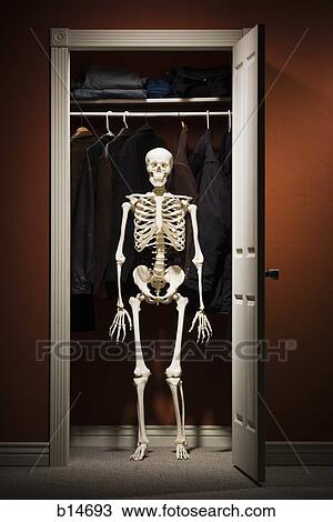Stock Image - Skeleton standing in closet. Fotosearch