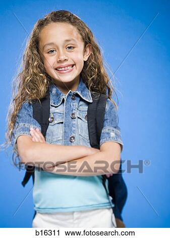 Smiling girl with arms crossed and backpack View Large Photo Image Stock Image - Smiling girl with arms crossed and backpack. Fotosearch