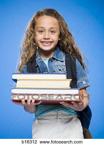 Smiling girl with backpack holding hardcover books View Large Photo Image Stock Image - Smiling girl with backpack holding hardcover books. Fotosearch