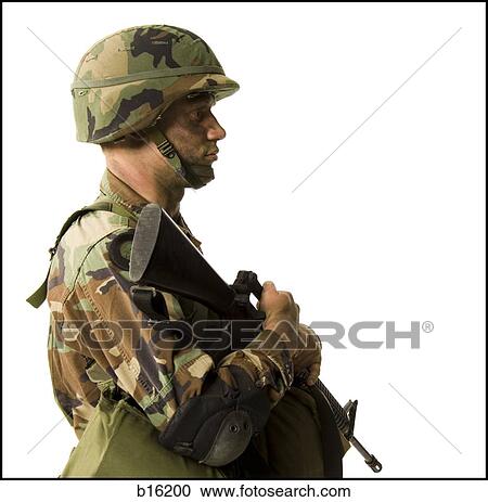 Stock Image - Soldier in uniform with gun. Fotosearch