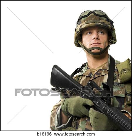 Soldier in uniform with gun View Large Photo Image Stock Photograph - Soldier in uniform with gun. Fotosearch