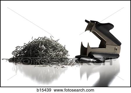 Stock Photo - Staple remover with pile of staples. Fotosearch
