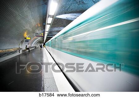 Picture - Subway platform with subway in motion. Fotosearch