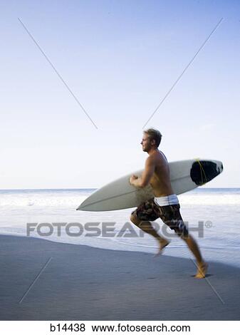 Surfer running on the beach. View Large Photo Image Stock Photo - Surfer running on the beach.. Fotosearch