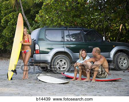 Surfers at the beach View Large Photo Image Stock Photo - Surfers at the beach. Fotosearch