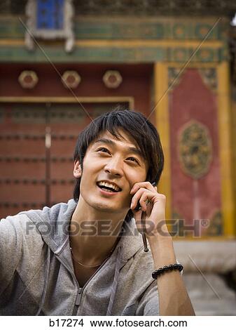 Teenage boy outdoors with cell phone smiling View Large Photo Image Picture - Teenage boy outdoors with cell phone smiling. Fotosearch