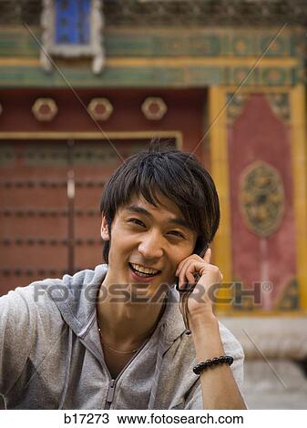 Teenage boy outdoors with cell phone smiling View Large Photo Image Stock Image - Teenage boy outdoors with cell phone smiling. Fotosearch