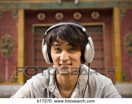 Teenage boy outdoors with headphones smiling View Large Photo Image Stock Image - Teenage boy outdoors with headphones smiling. Fotosearch