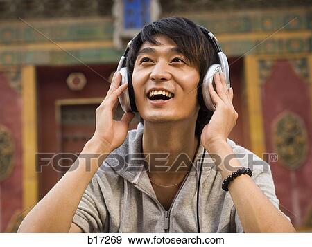 Teenage boy outdoors with headphones smiling View Large Photo Image Stock Photo - Teenage boy outdoors with headphones smiling. Fotosearch
