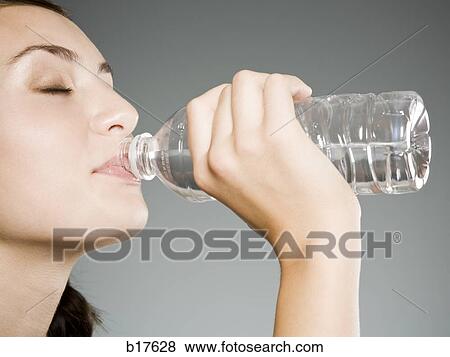 Teenage girl drinking bottled water View Large Photo Image Stock Photo - Teenage girl drinking bottled water. Fotosearch