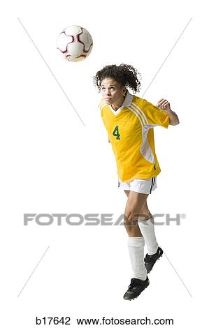 Teenage girl heading soccer ball View Large Photo Image Stock Image - Teenage girl heading soccer ball. Fotosearch
