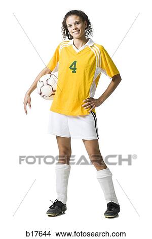 Teenage girl holding soccer ball smiling View Large Photo Image Picture - Teenage girl holding soccer ball smiling. Fotosearch