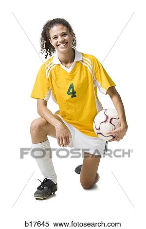 Teenage girl holding soccer ball smiling View Large Photo Image Stock Photography - Teenage girl holding soccer ball smiling. Fotosearch