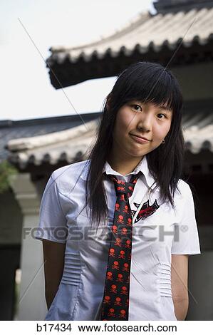 Teenage girl in school uniform smiling View Large Photo Image Picture - Teenage girl in school uniform smiling. Fotosearch