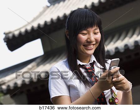 Teenage girl in school uniform smiling with mp3 player View Large Photo Image Stock Photograph - Teenage girl in school uniform smiling with mp3 player. Fotosearch