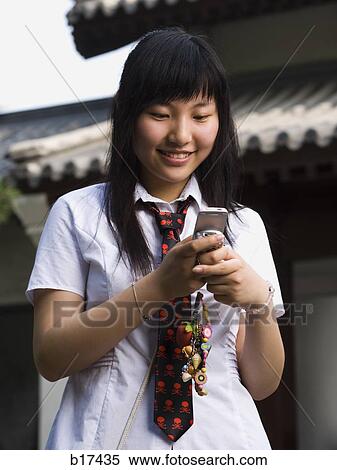 Teenage girl in school uniform smiling with mp3 player View Large Photo Image Stock Photography - Teenage girl in school uniform smiling with mp3 player. Fotosearch