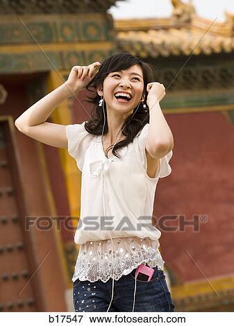 Teenage girl listening to mp3 player and dancing View Large Photo Image Stock Photo - Teenage girl listening to mp3 player and dancing. Fotosearch