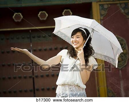 Teenage girl outdoors with umbrella smiling View Large Photo Image Stock Image - Teenage girl outdoors with umbrella smiling. Fotosearch