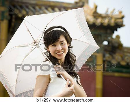 Teenage girl outdoors with umbrella smiling View Large Photo Image Stock Photo - Teenage girl outdoors with umbrella smiling. Fotosearch