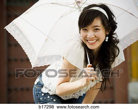 Teenage girl outdoors with umbrella smiling View Large Photo Image Stock Photo - Teenage girl outdoors with umbrella smiling. Fotosearch
