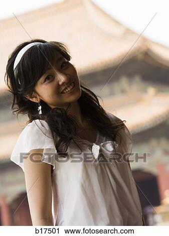Stock Image - Teenage girl posing and smiling. Fotosearch