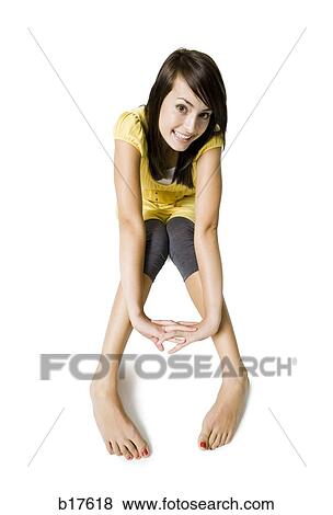 Stock Photo - Teenage girl sitting and smiling. Fotosearch