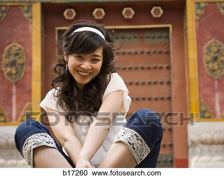 Teenage girl sitting outdoors smiling View Large Photo Image Stock Image - Teenage girl sitting outdoors smiling. Fotosearch