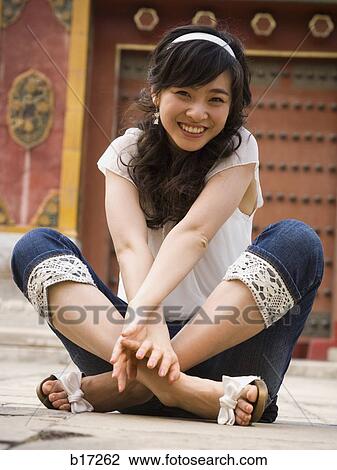Teenage girl sitting outdoors smiling View Large Photo Image Stock Image - Teenage girl sitting outdoors smiling. Fotosearch
